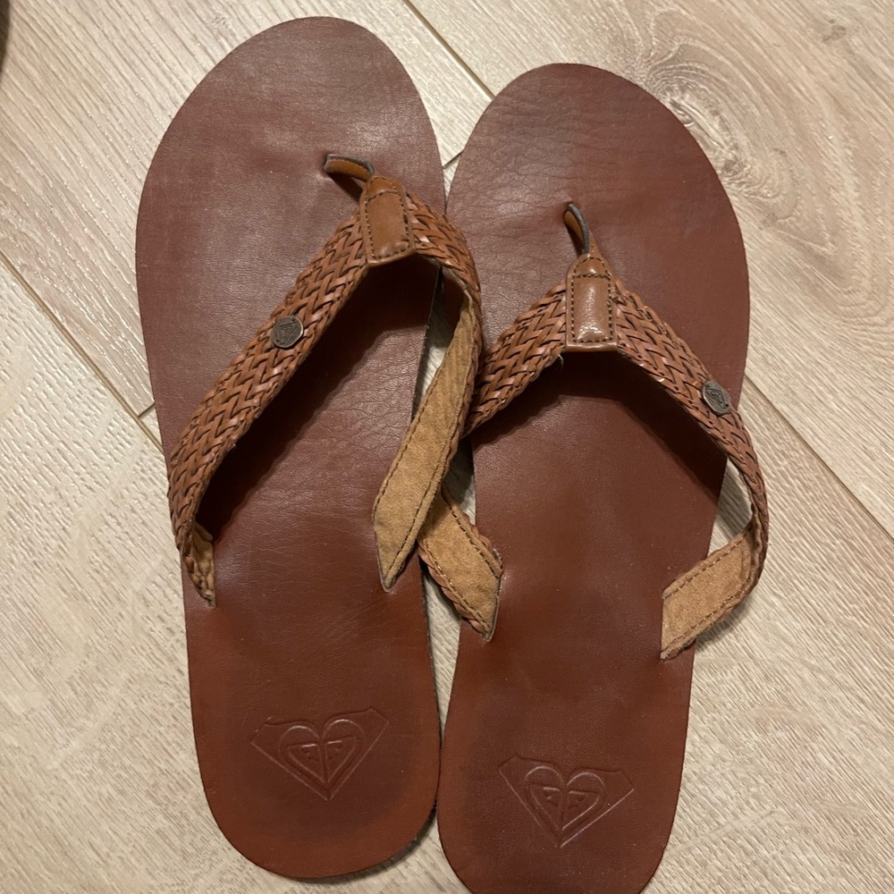 Tan woven flip flops